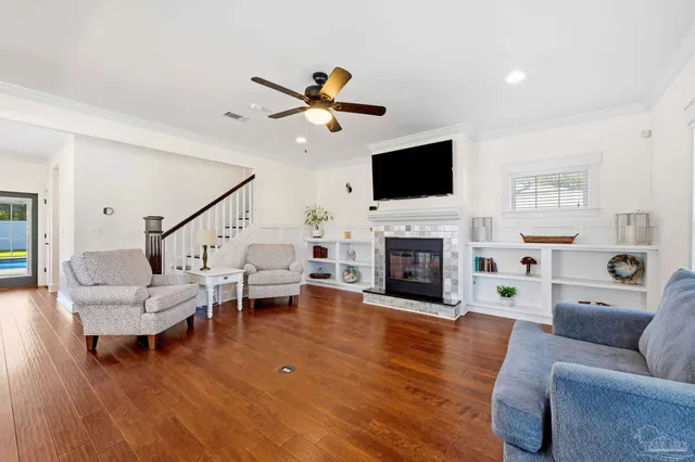 a living room with furniture a fireplace and a flat screen tv