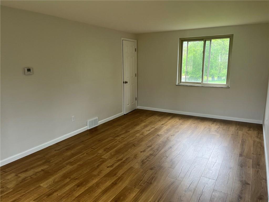 1466 Cathell Road Pittsburgh, PA 15236 - Photo 3 of 32 a view of an empty room with wooden floor and a window