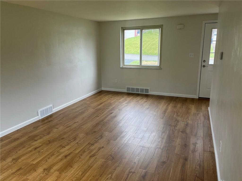 1466 Cathell Road Pittsburgh, PA 15236 - Photo 4 of 32 an empty room with wooden floor and windows