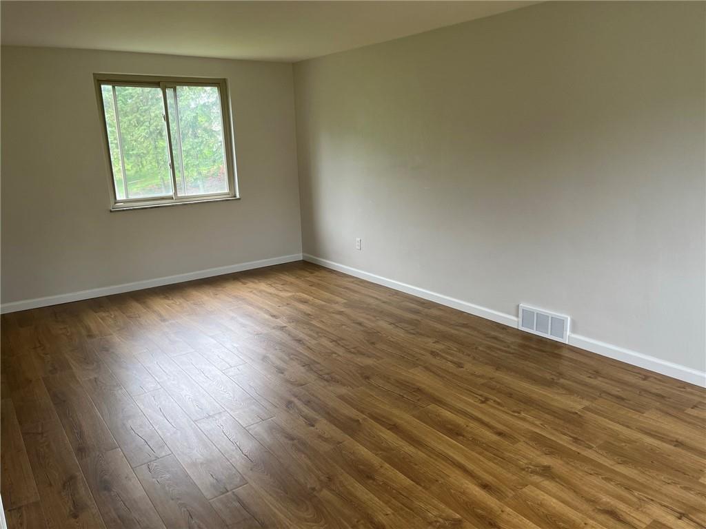 1466 Cathell Road Pittsburgh, PA 15236 - Photo 5 of 32 a view of an empty room with wooden floor and a window