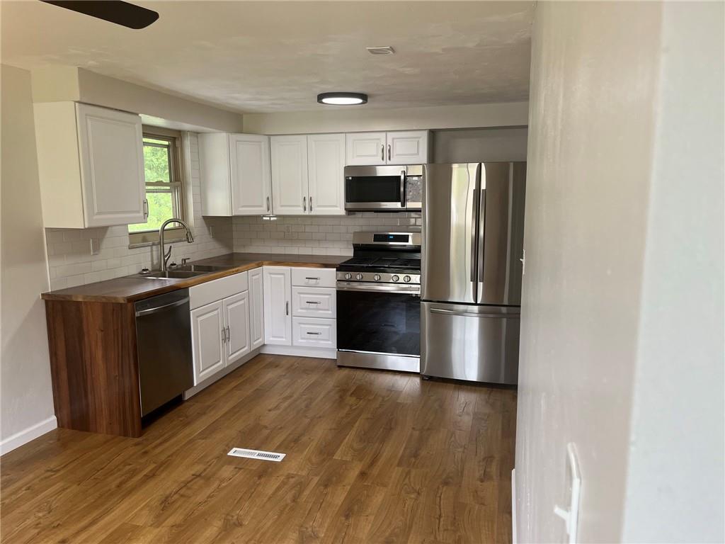 1466 Cathell Road Pittsburgh, PA 15236 - Photo 6 of 32 a kitchen with stainless steel appliances granite countertop a stove a sink and a refrigerator