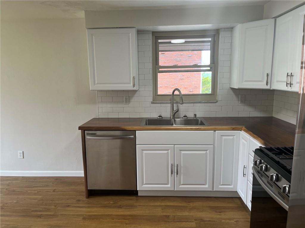 1466 Cathell Road Pittsburgh, PA 15236 - Photo 7 of 32 a kitchen with stainless steel appliances granite countertop a sink stove and microwave
