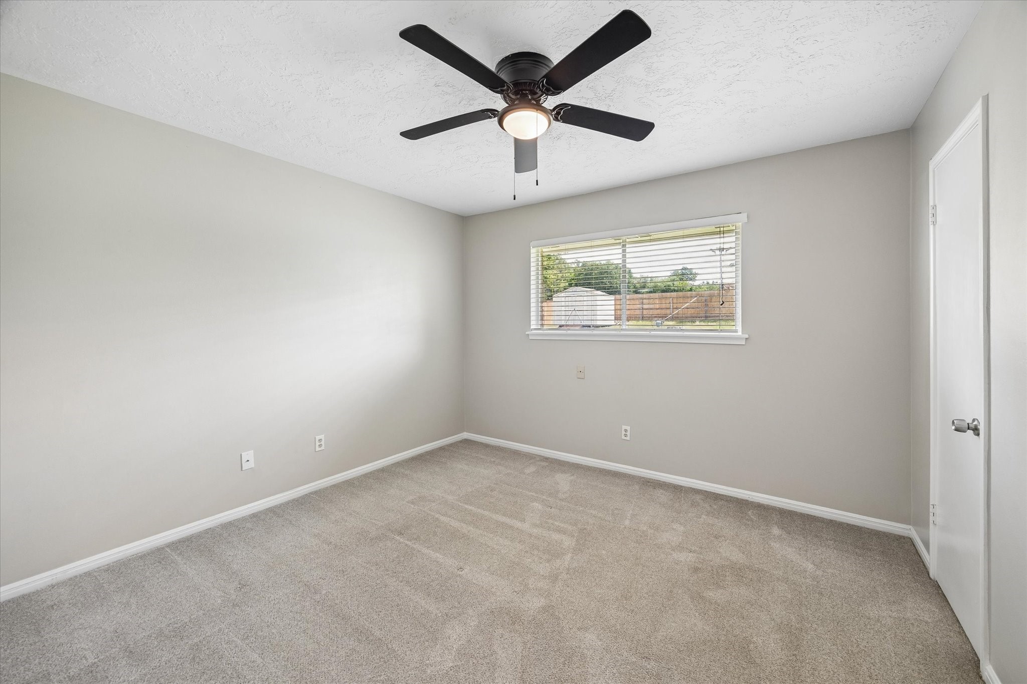 25114 Spring Ridge Drive Spring, TX 77386 - Photo 16 of 24 an empty room with a window and a ceiling fan