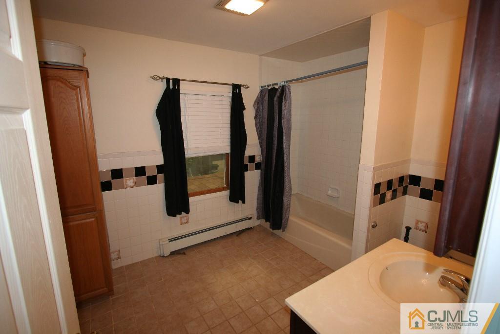 5 Washington Road Sayreville, NJ 08859 - Photo 12 of 20 a bathroom with a tub and a shower