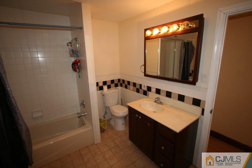 5 Washington Road Sayreville, NJ 08859 - Photo 13 of 20 a bathroom with a sink a toilet a mirror and shower