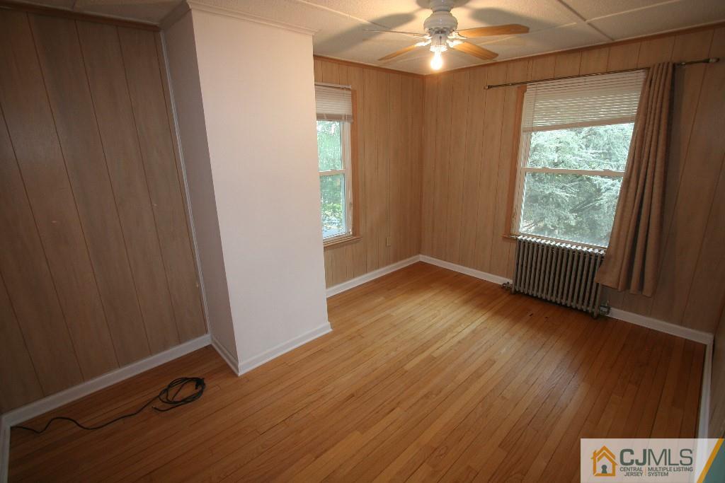 5 Washington Road Sayreville, NJ 08859 - Photo 16 of 20 an empty room with wooden floor and windows