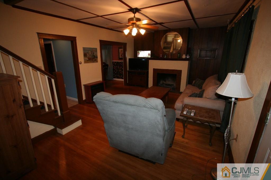 5 Washington Road Sayreville, NJ 08859 - Photo 3 of 20 a living room with furniture a fireplace and a flat screen tv