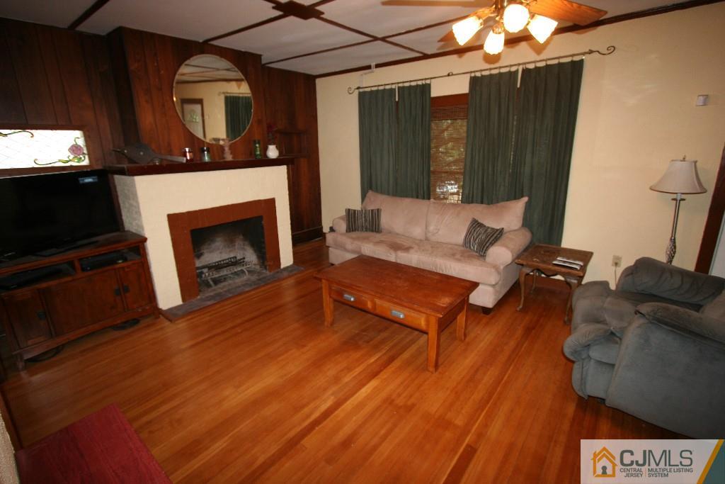 5 Washington Road Sayreville, NJ 08859 - Photo 4 of 20 a living room with furniture and a fireplace