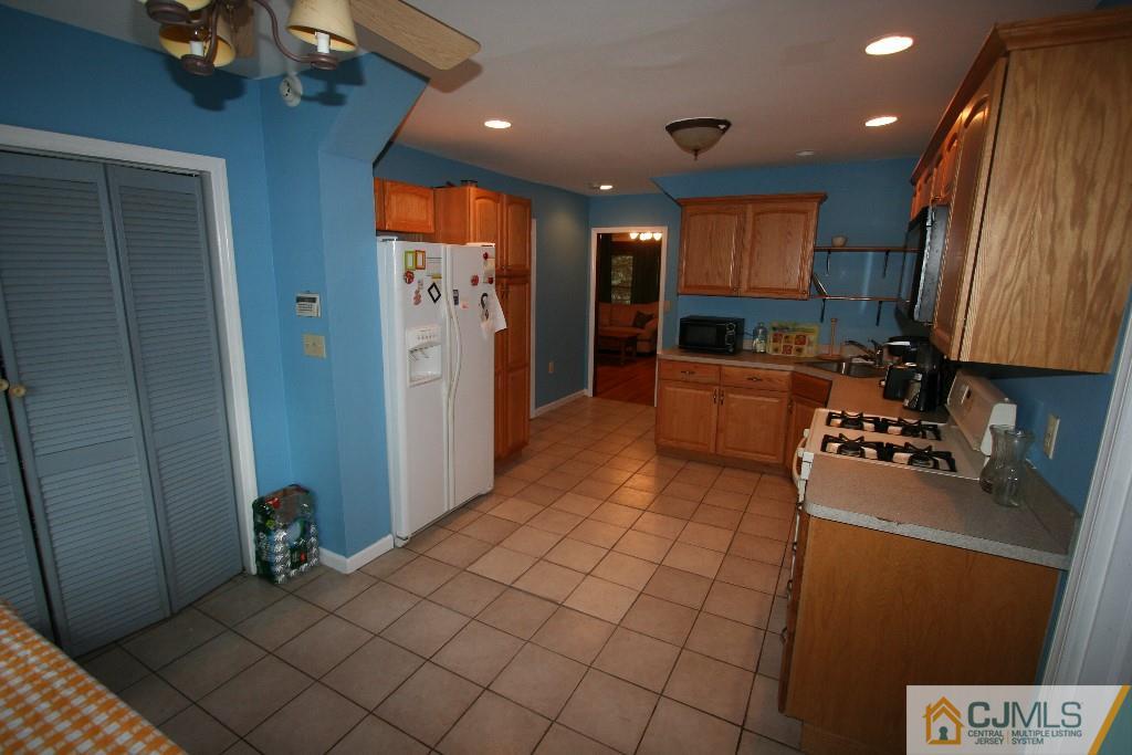 5 Washington Road Sayreville, NJ 08859 - Photo 8 of 20 a kitchen with stainless steel appliances granite countertop a refrigerator and a stove top oven