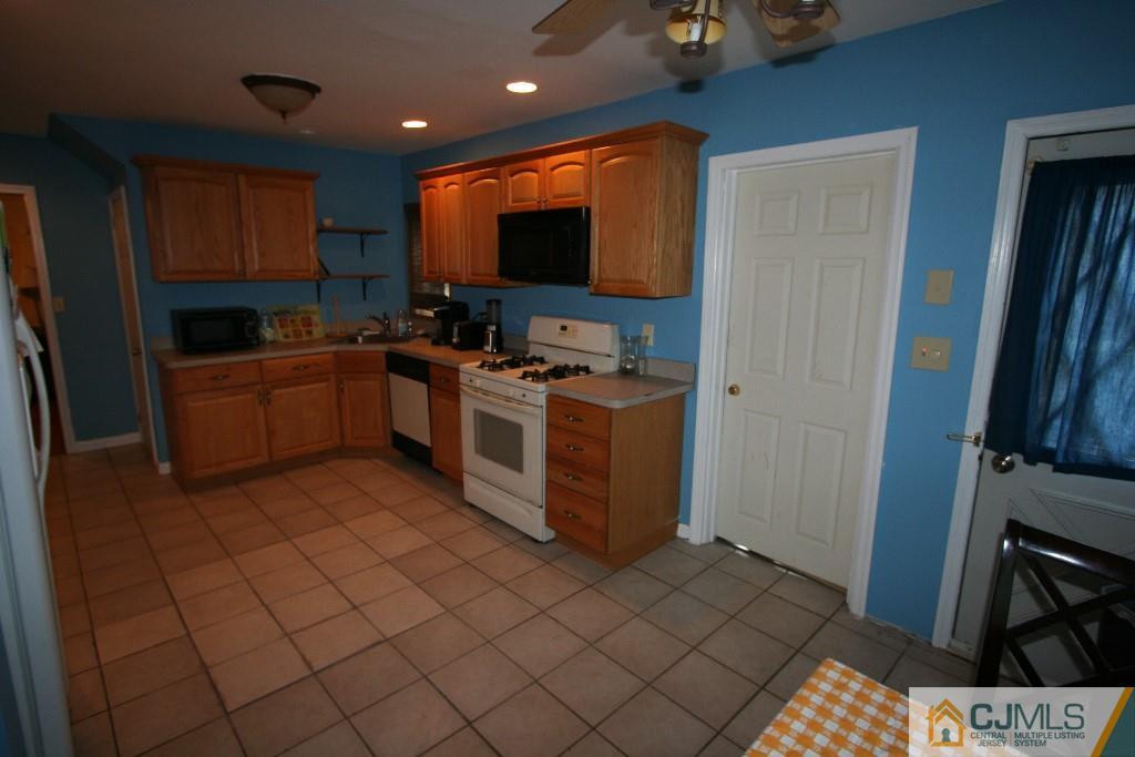 5 Washington Road Sayreville, NJ 08859 - Photo 9 of 20 a kitchen with stainless steel appliances granite countertop a stove a sink and a refrigerator
