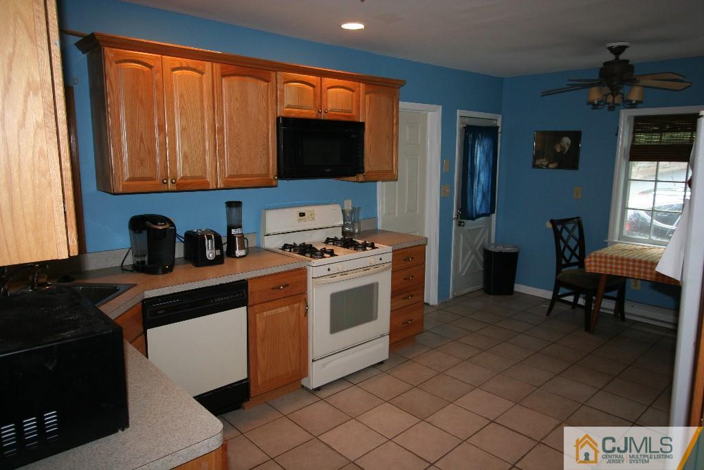 5 Washington Road Sayreville, NJ 08859 - Photo 10 of 20 a kitchen with stainless steel appliances a stove a sink and a microwave