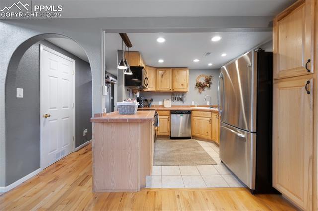 608 Slater Creek Road Guffey, CO 80820 - Photo 29 of 47 Kitchen with light brown cabinets, appliances with stainless steel finishes, decorative light fixtures, light wood-style floors, and recessed lighting