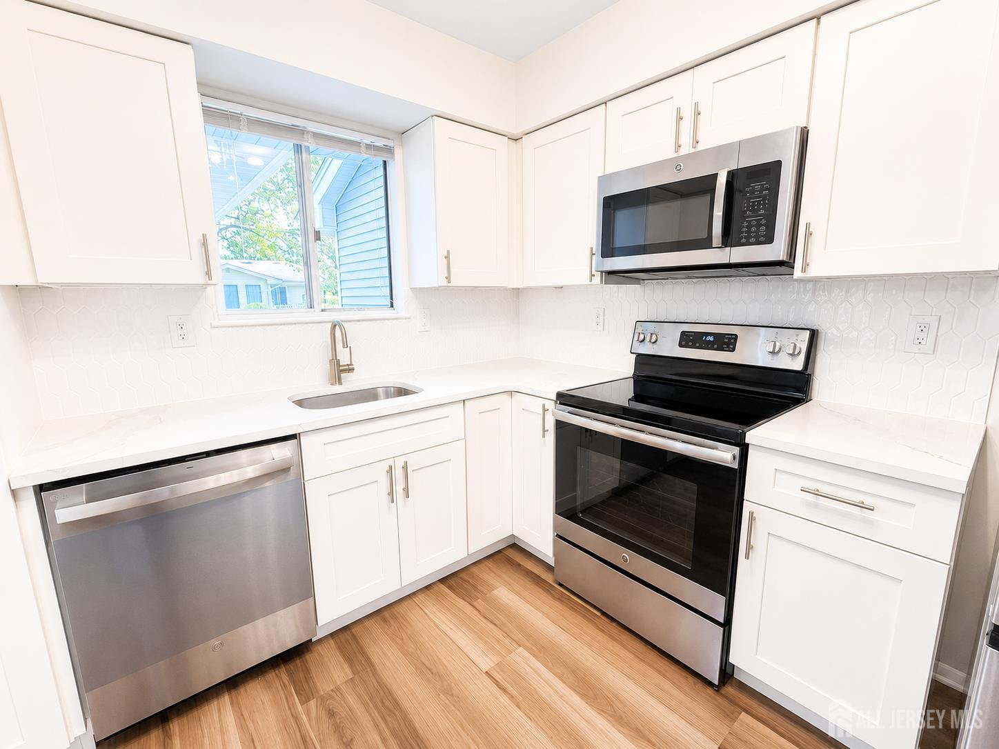 621 A Deal Road Monroe Township, NJ 08831 - Photo 8 of 27 a kitchen with stainless steel appliances a stove microwave and sink