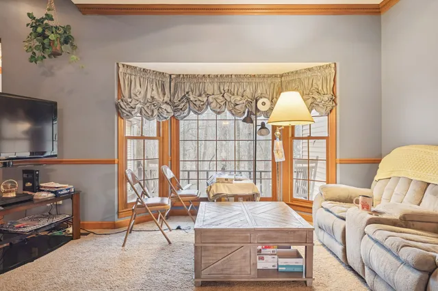 a view of a livingroom with furniture and a flat screen tv