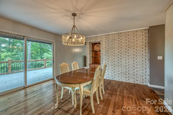 a view of a dining room with furniture wooden floor and chandelier