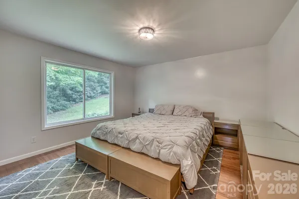 a bed sitting in a room next to a window