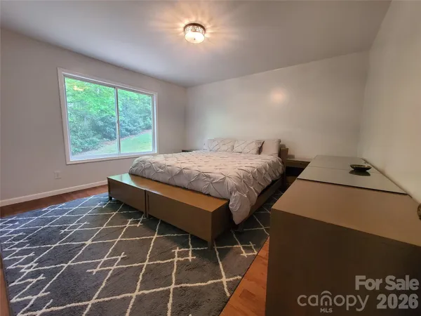 a bed sitting in a bedroom next to a window