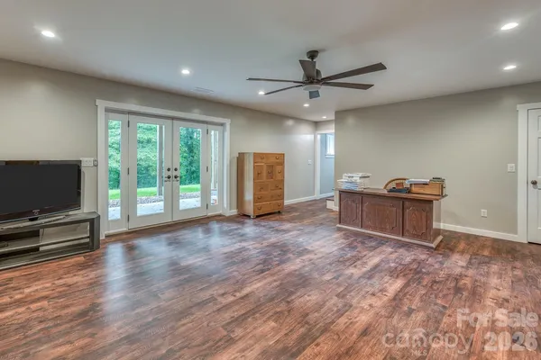 a view of a livingroom with furniture and a flat screen tv