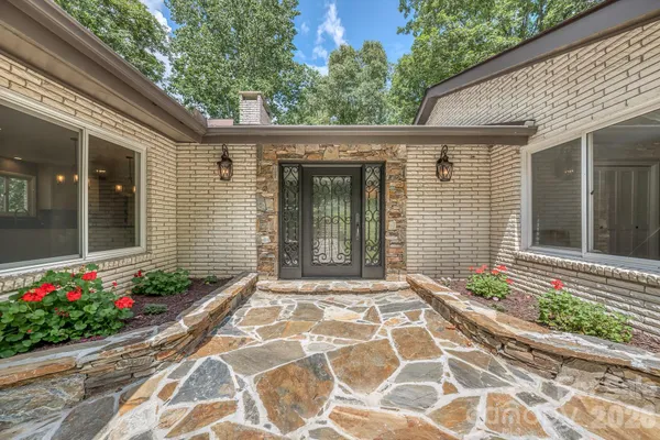 a front view of a house with a garden