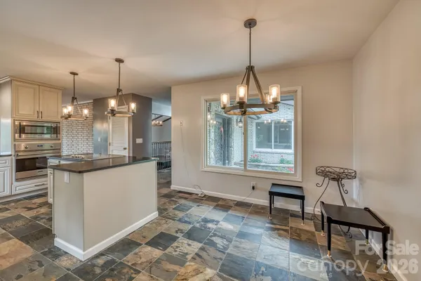 a view of a kitchen and dining table chairs