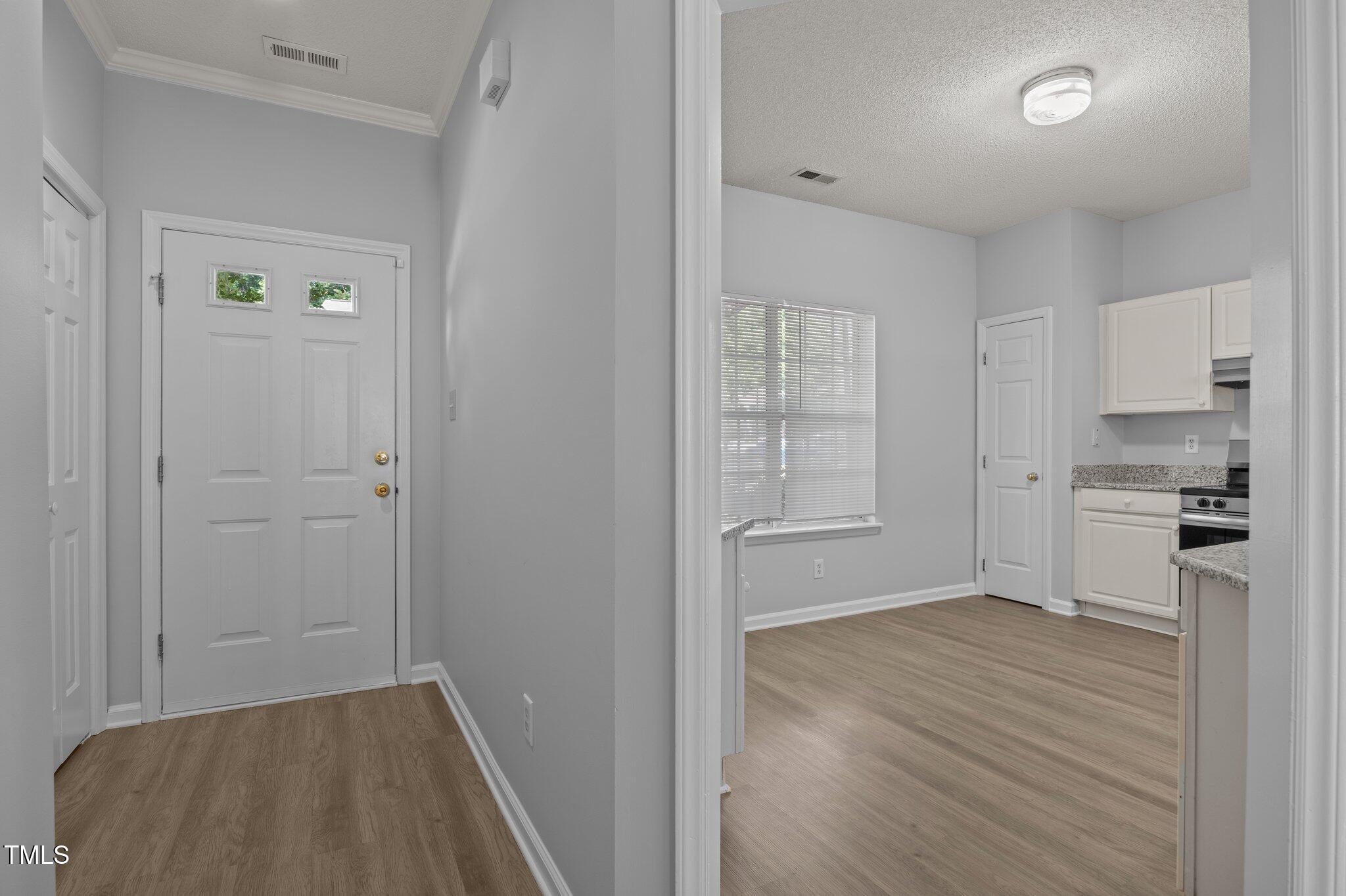 4406 Still Pines Drive Raleigh, NC 27613 - Photo 6 of 39 a view of kitchen with wooden floor electronic appliances and window