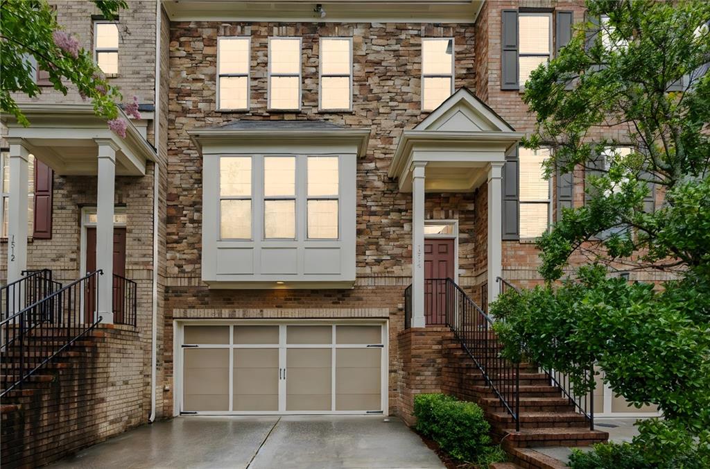 1514 Woodbridge Way Northeast Atlanta, GA 30329 - Photo 1 of 54 a front view of a house with a yard