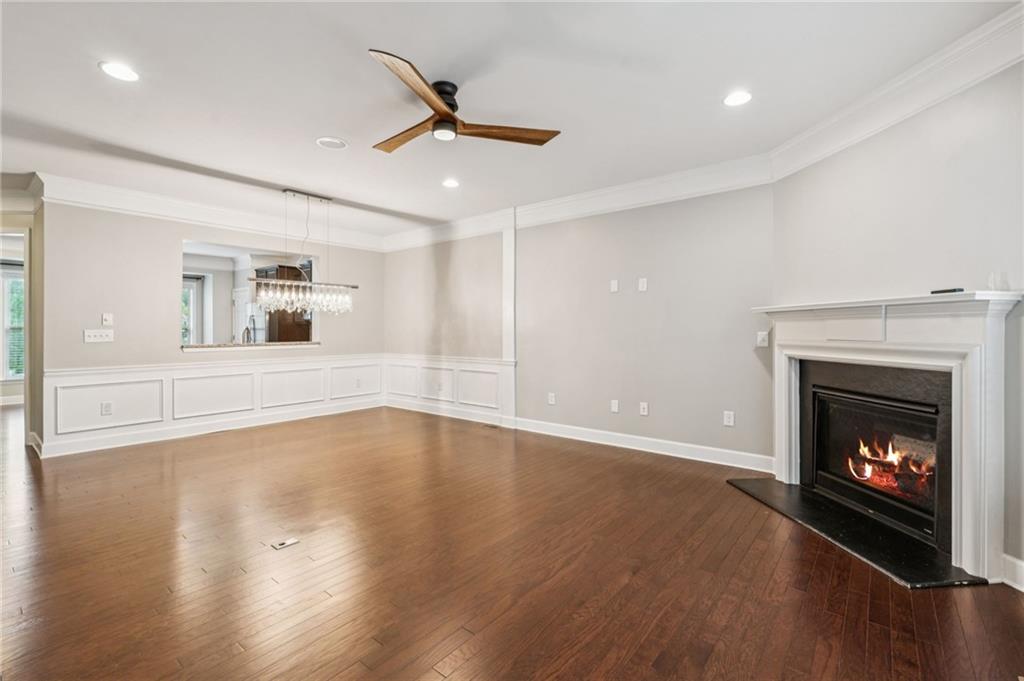1514 Woodbridge Way Northeast Atlanta, GA 30329 - Photo 17 of 54 a view of an empty room with wooden floor fireplace and a window