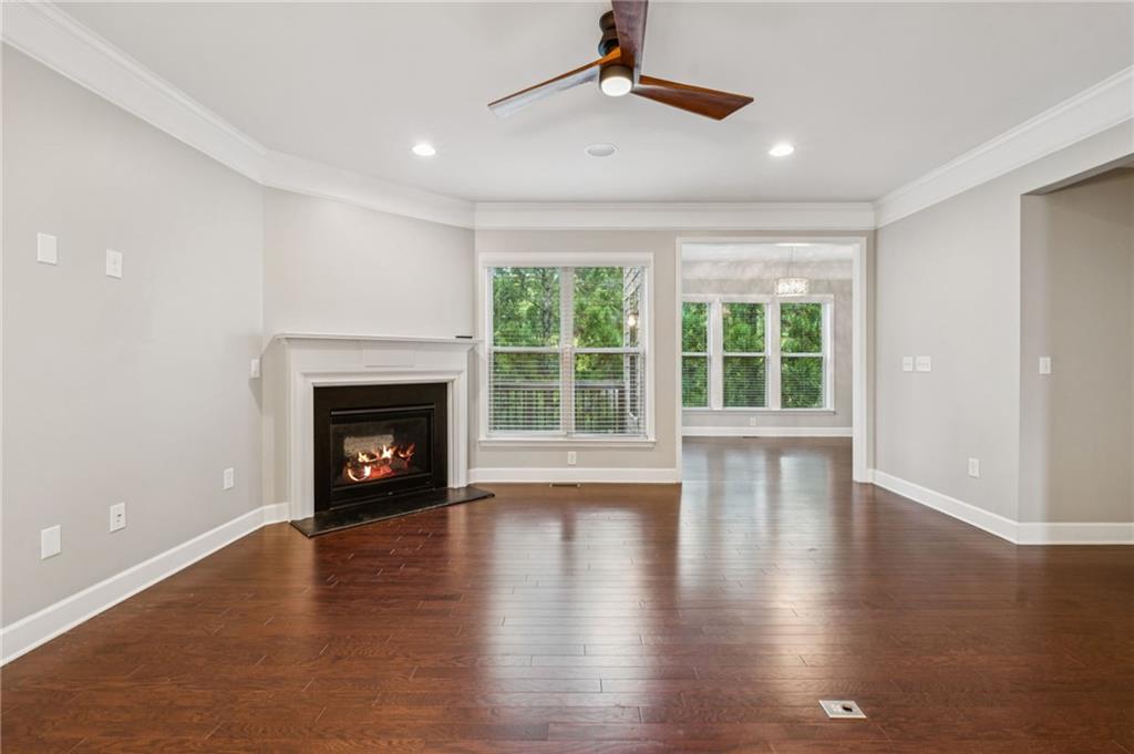1514 Woodbridge Way Northeast Atlanta, GA 30329 - Photo 18 of 54 a view of an empty room with wooden floor fireplace and a window