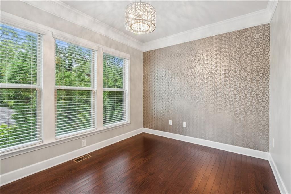1514 Woodbridge Way Northeast Atlanta, GA 30329 - Photo 21 of 54 a view of an empty room with wooden floor and a window