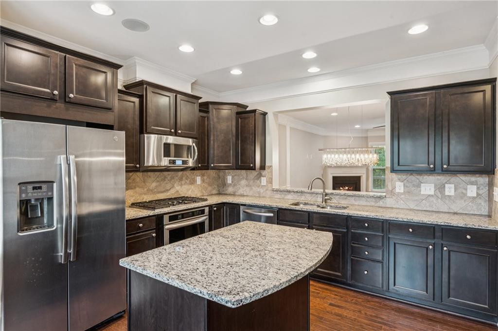 1514 Woodbridge Way Northeast Atlanta, GA 30329 - Photo 22 of 54 a kitchen with stainless steel appliances granite countertop a sink stove and refrigerator