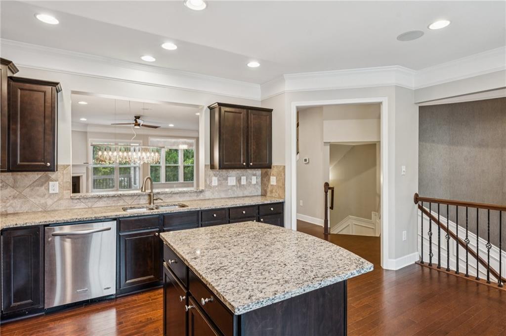 1514 Woodbridge Way Northeast Atlanta, GA 30329 - Photo 23 of 54 a kitchen with granite countertop kitchen island wooden cabinets and stainless steel appliances