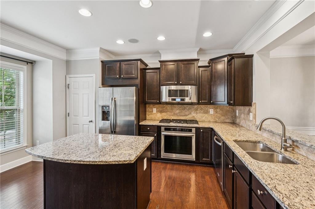1514 Woodbridge Way Northeast Atlanta, GA 30329 - Photo 25 of 54 a kitchen with stainless steel appliances granite countertop a sink stove microwave and refrigerator