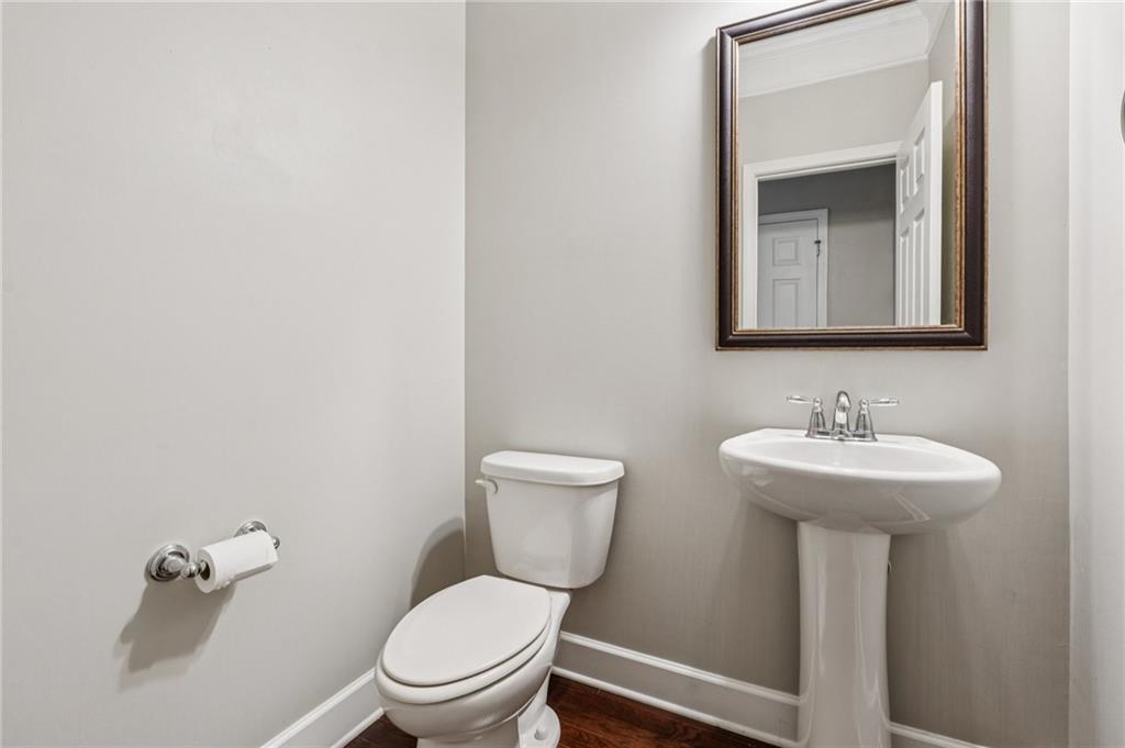 1514 Woodbridge Way Northeast Atlanta, GA 30329 - Photo 28 of 54 a bathroom with a toilet a sink and mirror