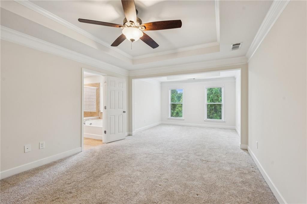 1514 Woodbridge Way Northeast Atlanta, GA 30329 - Photo 30 of 54 en empty room with windows and ceiling fan