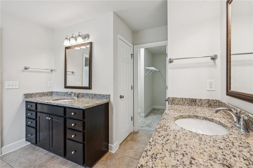 1514 Woodbridge Way Northeast Atlanta, GA 30329 - Photo 33 of 54 a bathroom with a granite countertop sink and a mirror