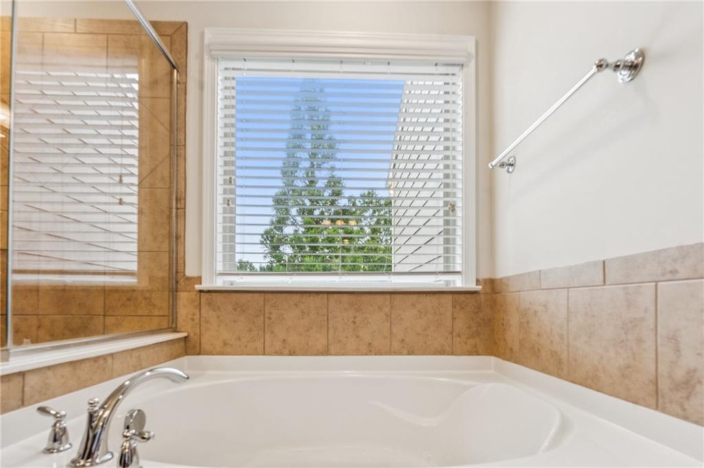 1514 Woodbridge Way Northeast Atlanta, GA 30329 - Photo 36 of 54 a white bath tub sitting in a bathroom next to a window