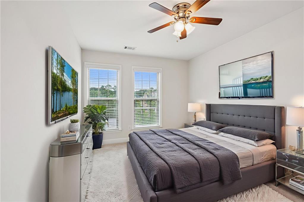 1514 Woodbridge Way Northeast Atlanta, GA 30329 - Photo 37 of 54 a bedroom with a large bed and a chandelier