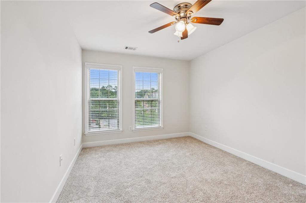 1514 Woodbridge Way Northeast Atlanta, GA 30329 - Photo 38 of 54 an empty room with windows and fan