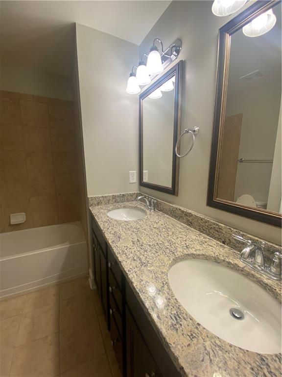 1514 Woodbridge Way Northeast Atlanta, GA 30329 - Photo 40 of 54 a bathroom with a granite countertop sink and a mirror