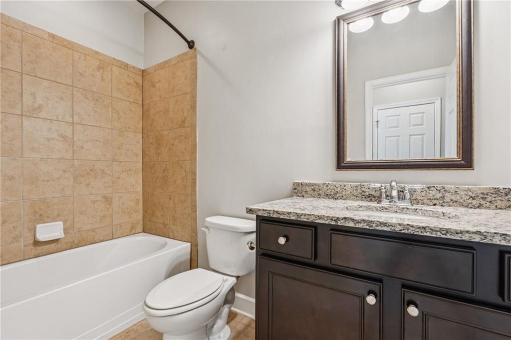 1514 Woodbridge Way Northeast Atlanta, GA 30329 - Photo 43 of 54 a bathroom with a granite countertop toilet sink and mirror