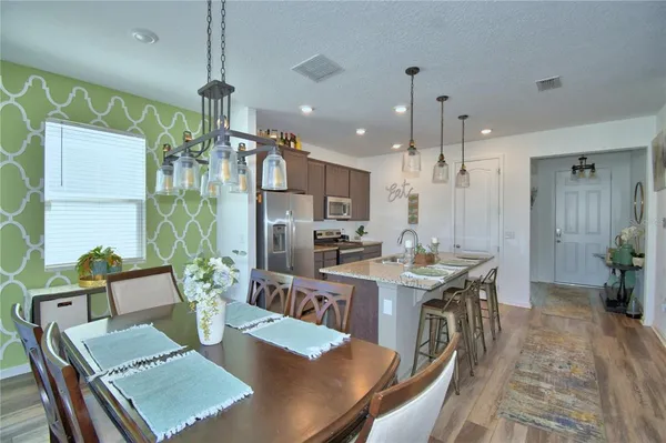 a living room with furniture and kitchen view