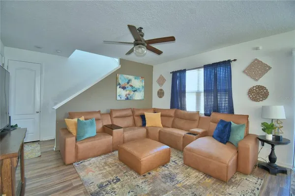 a living room with furniture a fireplace and a table