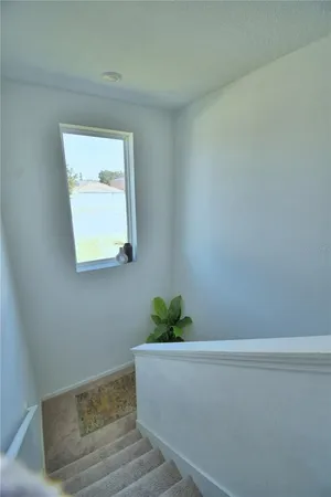 a bedroom with a bed and a night stand