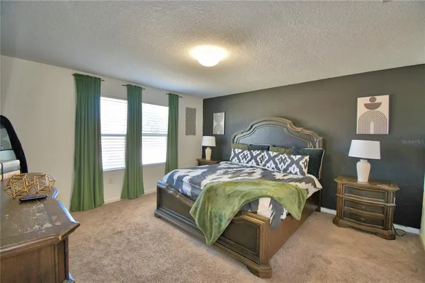 a bedroom with a bed and a television