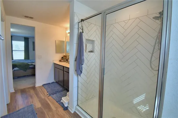 a bathroom with a sink vanity granite and a mirror