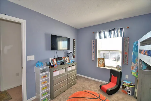 a bedroom with a bed and a table in it