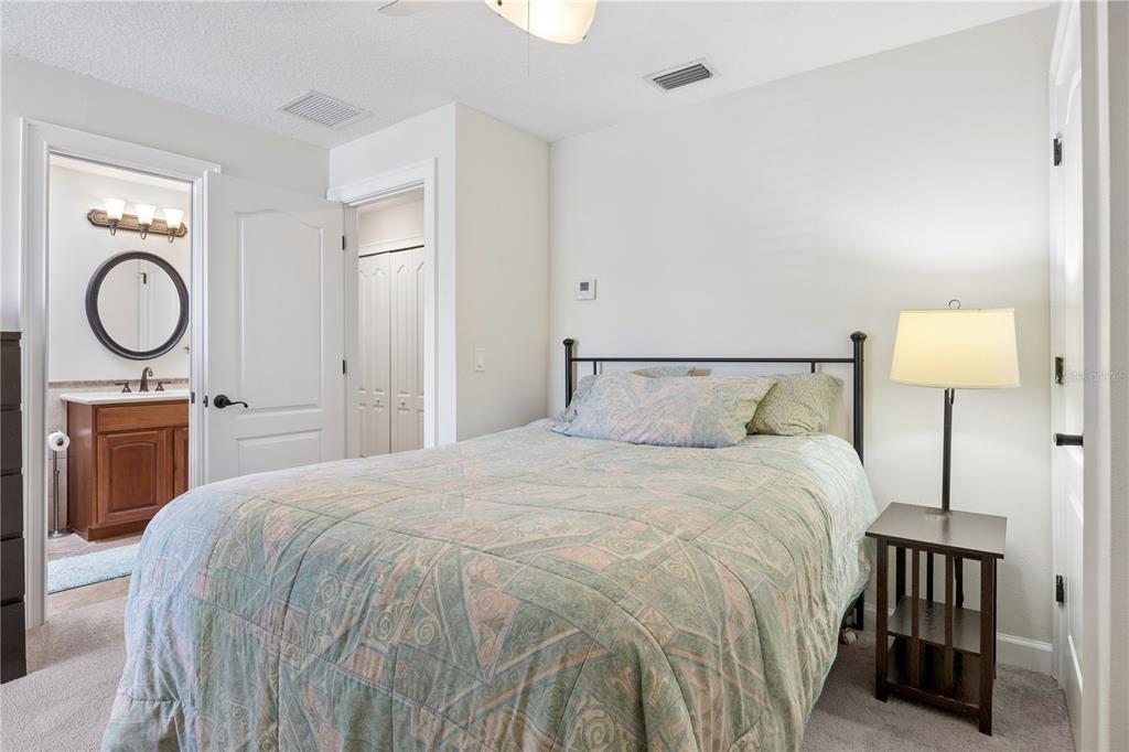 11325 Preston Cove Road Clermont, FL 34711 - Photo 36 of 58 a bedroom with a bed and a lamp