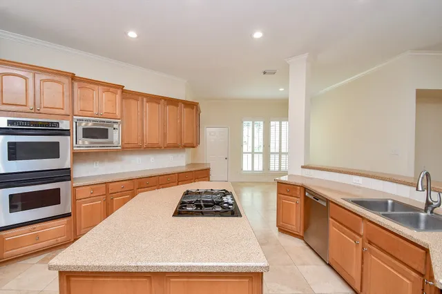 a kitchen with stainless steel appliances granite countertop a stove and a sink