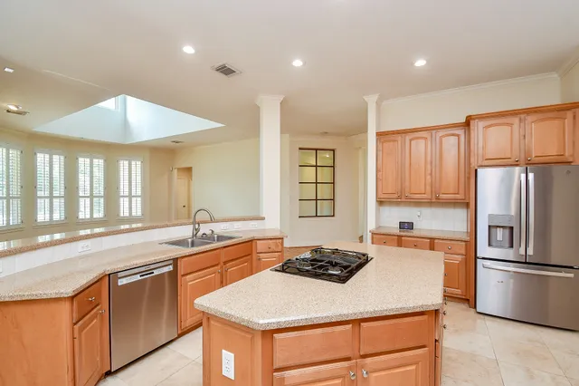 a kitchen with stainless steel appliances a sink stove and refrigerator
