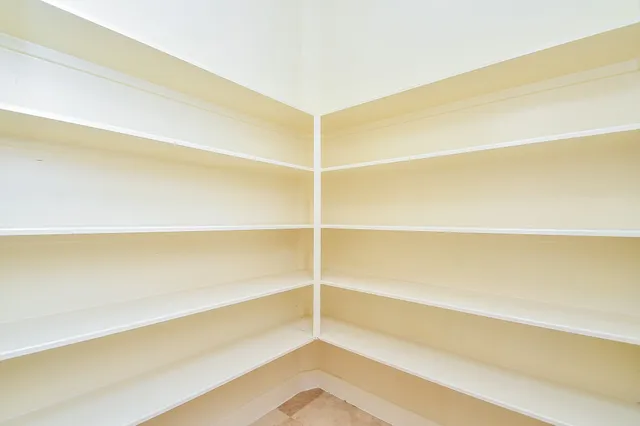 a view of a room with wooden floor and a window